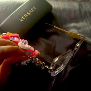 Versace glasses that come with case, cleaner cloth, and clear lenses. Used once.